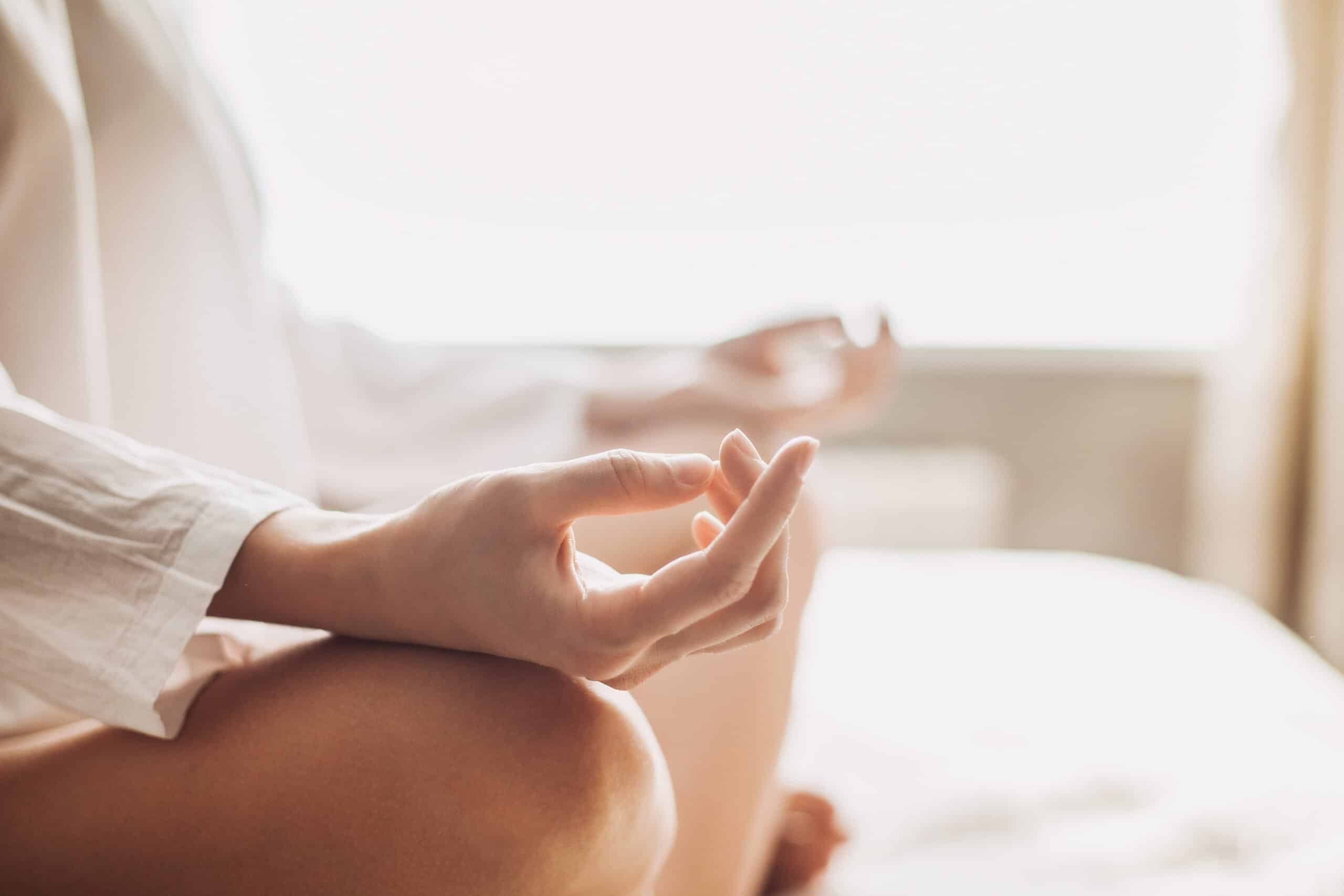 A woman practicing meditation for addiction.