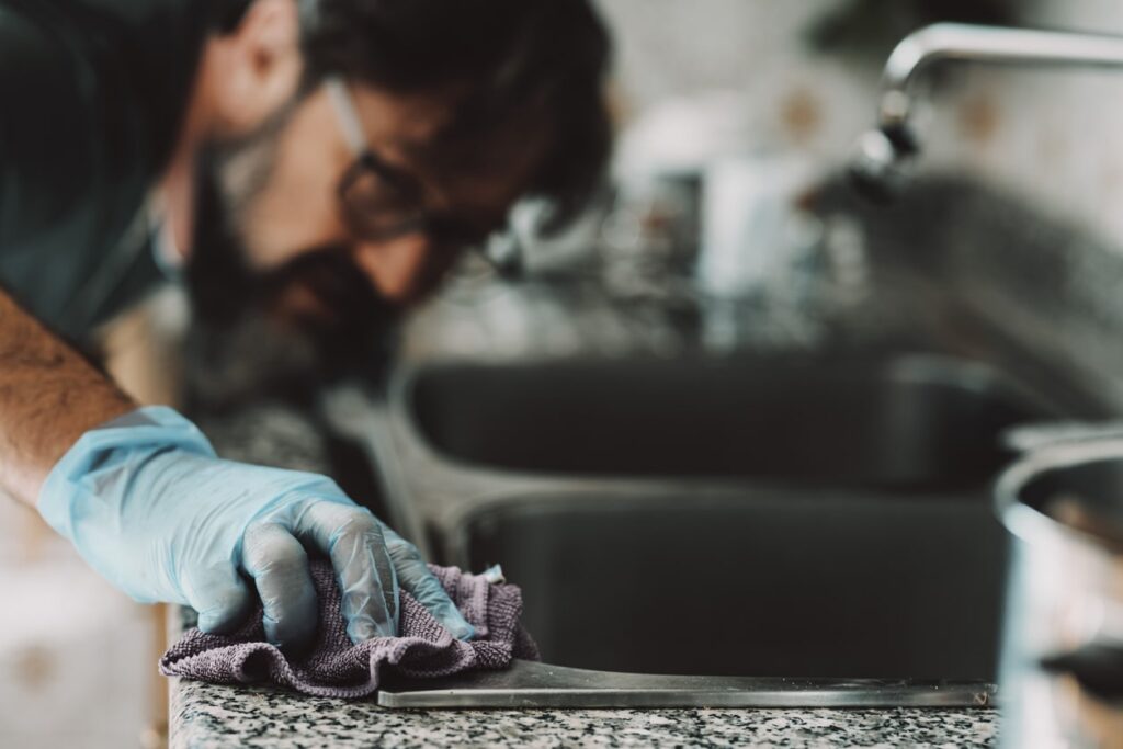 man compulsively cleaning his kitchen