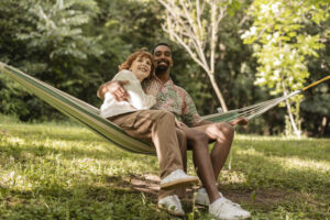 A happy couple relaxing on a hammock after getting treatment with a addiction severity index test.